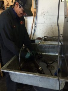 Luis cleaning diesel parts